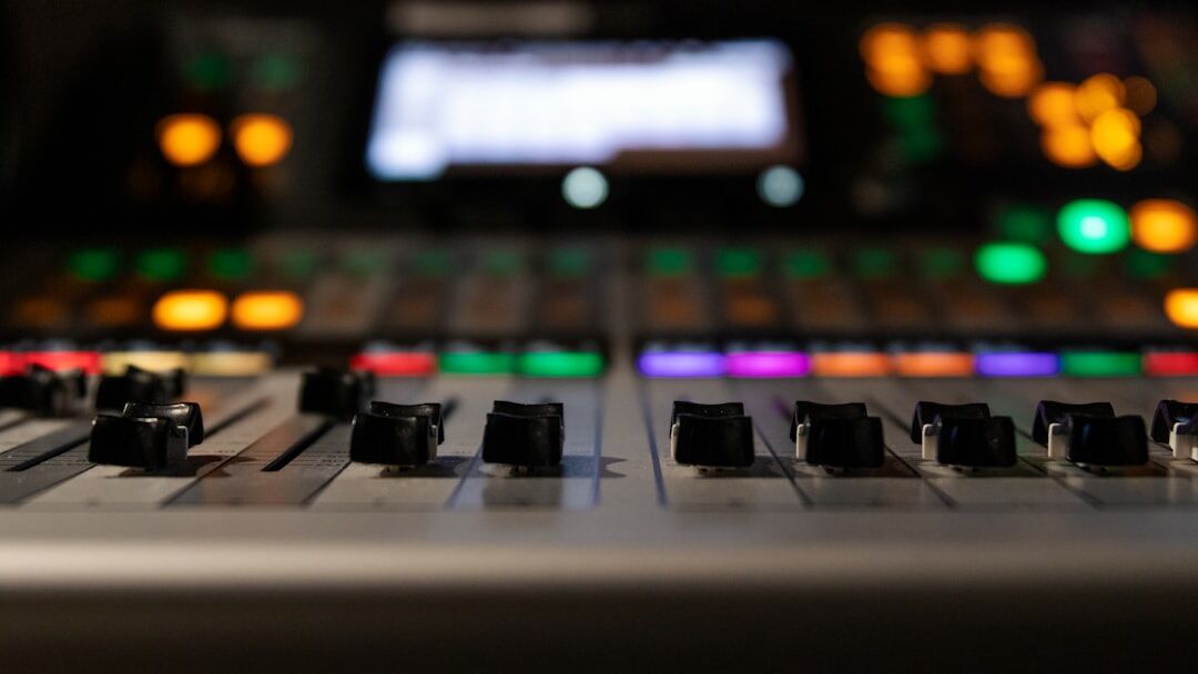 Close up of a video switcher and vision mixer panel with glowing buttons