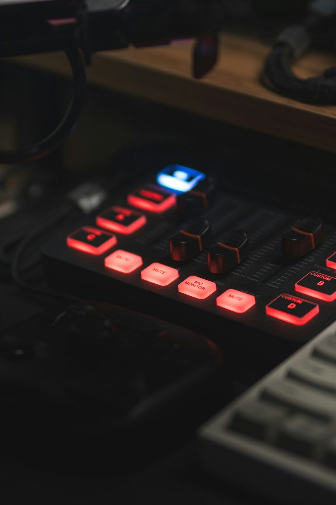 Hands operating a live streaming control panel with waveform on laptop screen
