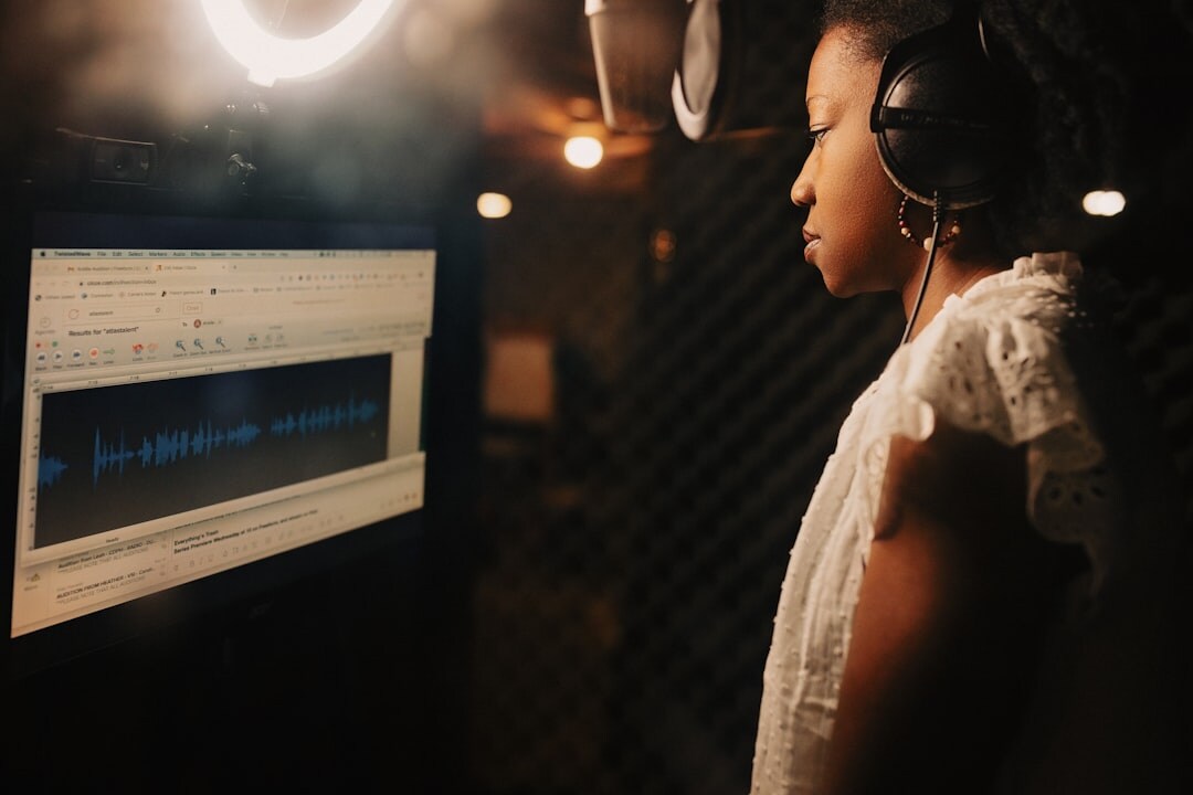 Woman with headset reviewing live footage on a monitor